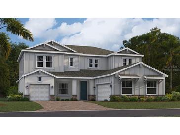 Two-story home with gray siding, two-car garage, and landscaping at 760 Terrapin Dr, Debary, FL 32713