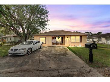 Cute one-story home with a landscaped yard and driveway at 1375 6 Iron Dr, Lakeland, FL 33801
