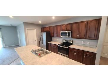 Modern kitchen featuring stainless steel appliances and ample cabinetry at 2986 Greenhill Way, Saint Cloud, FL 34772