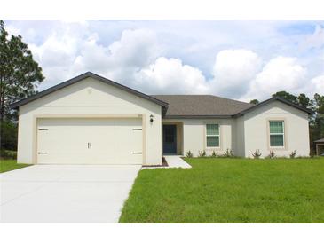 Newly constructed home with a two-car garage and well-manicured lawn at 305 Bass Ln, Poinciana, FL 34759