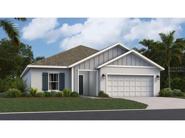 One-story home with gray siding, white trim, and a two-car garage at 462 Puma Loop, Groveland, FL 34736