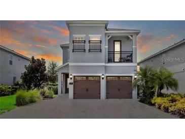 Two-story house with two-car garage and balcony at 7650 Fairfax Dr, Kissimmee, FL 34747