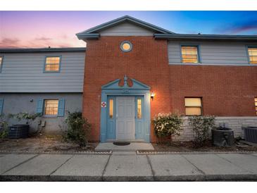 Inviting brick building exterior, featuring a well-lit entrance and landscaping at 7340 Daniel Webster Dr # 6, Winter Park, FL 32792