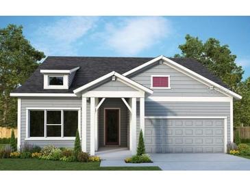 Two-story craftsman style home with gray siding and a two-car garage at 3088 Expedition Dr, Saint Cloud, FL 34771