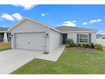 One-story home with a two-car garage and landscaped lawn at 524 Scenic Bluff Blvd, Lake Wales, FL 33853