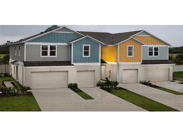Three-unit townhome building with attached garages and landscaping at 3848 King Hill Dr, Haines City, FL 33844