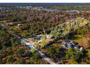 Aerial view of a house nestled within a sprawling wooded lot at 2468 Fawn Run, Oviedo, FL 32765