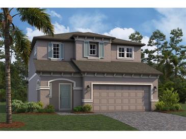Two-story house with gray siding, light teal door, and a two-car garage at 4897 Foxglove Dr, Lakeland, FL 33811
