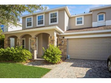 Two-story house with stone accents and a two-car garage at 2807 Polson Dr, Kissimmee, FL 34758