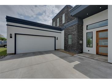 Modern home with attached two-car garage and stone facade at 3225 Parkwood Ct, Kissimmee, FL 34744