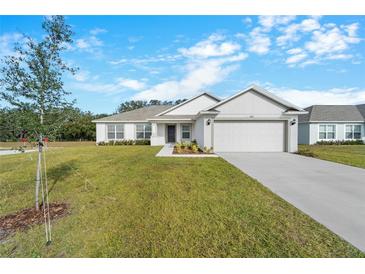 Newly built home with a two-car garage and landscaped lawn at 2162 Hadley Rd, Bartow, FL 33830