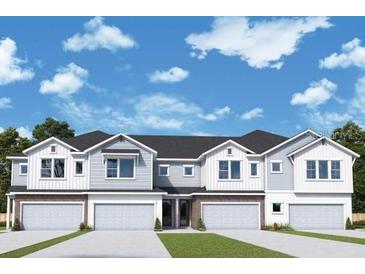 Three-unit townhome building with attached garages and neutral color scheme at 520 Astera Winds Ln, Lake Mary, FL 32746