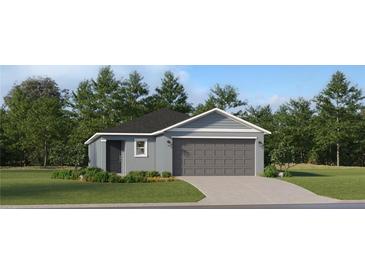 Single-story home with gray siding, gray garage door, and landscaping at 838 Hour Glass Rd, Lakeland, FL 33801