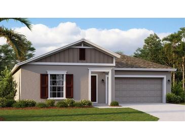 One-story home with gray siding, brown accents, and a two-car garage at 4776 Cloister St, Kissimmee, FL 34758