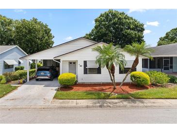 White single story home with carport and landscaping at 1967 Long Boat Dr, Lakeland, FL 33810