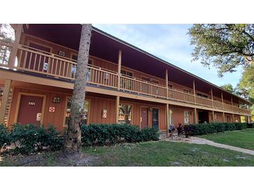 Two-story building with balconies and landscaping at 3200 River Ranch Blvd # 204, River Ranch, FL 33867