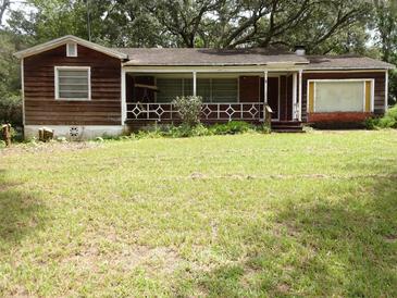 Older home with wood siding and a small front porch at 217 Catalonia Ave, De Leon Springs, FL 32130