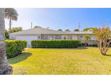 Tan one-story house with attached garage at 100 Talo Cir, Port Orange, FL 32127