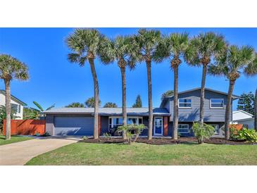 Two-story home with gray siding and palm trees at 3 Wisteria Dr, Ormond Beach, FL 32176