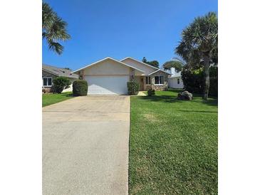 Single-story home with driveway and landscaping at 833 E 22Nd Ave, New Smyrna Beach, FL 32169