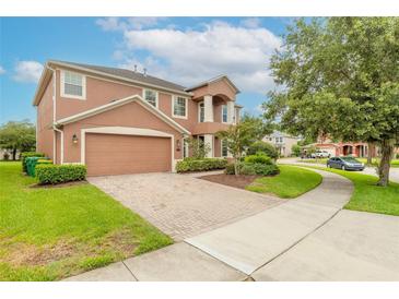 Two story house with brick driveway and landscaped yard at 206 Laurel Point Ct, Deland, FL 32724