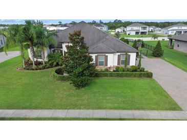 Luxury home with manicured landscaping and a paved driveway at 2273 Grayling St, Orlando, FL 32820