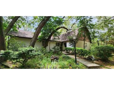 Charming house nestled amongst lush greenery, offering curb appeal at 711 Sunset Ave, Orange City, FL 32763