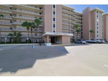 Sandcastle North building exterior with ample parking at 4435 S Atlantic Ave # 414, Ponce Inlet, FL 32127