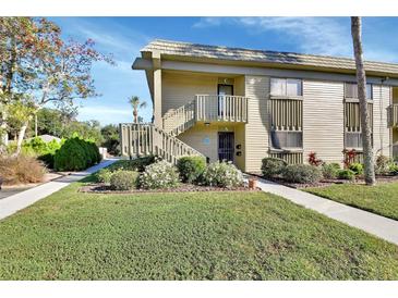 Exterior view of condo building with landscaping and walkway at 600 N Boundary Ave # 101A, Deland, FL 32720