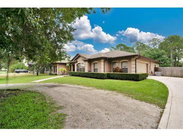 House exterior showcasing landscaping and driveway at 227 Fort Florida Rd, Debary, FL 32713