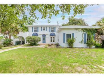Two-story house with a white exterior, blue accents, and a green lawn at 724 N Oleander Ave, Daytona Beach, FL 32118