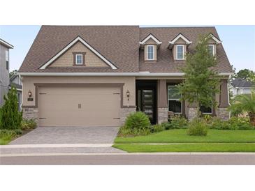 Two-story house with a brown roof, beige siding, and stone accents at 6287 Woodhaven Village Dr, Port Orange, FL 32128