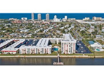Aerial view of waterfront condo community with pool and private pier at 2711 N Halifax Ave # 296, Daytona Beach, FL 32118
