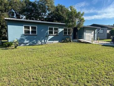 Ranch style home with light blue exterior and a spacious yard at 333 Beresford Ave, Deland, FL 32724
