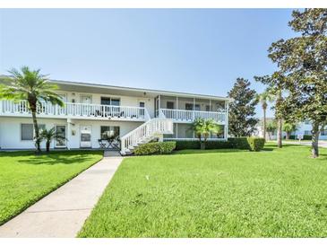 White building with stairs, balconies, and a grassy yard at 1140 S Orlando Ave # F-16, Maitland, FL 32751