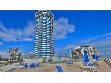 Oceanfront high-rise building with tennis courts and seating area at 2625 S Atlantic Ave # 24Nw, Daytona Beach, FL 32118