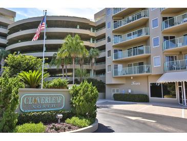 Cloverleaf North community entrance with lush landscaping and building view at 4 Oceans West Blvd # 407B, Daytona Beach Shores, FL 32118