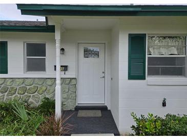Charming home exterior with white door and green shutters at 201 N Hill Ave # 150, Deland, FL 32724