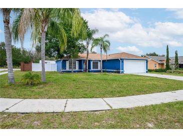 Charming blue house with mature landscaping and a two-car garage at 1171 Daimler Dr, Apopka, FL 32712