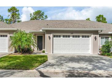 Two-car garage and front entry of charming home at 425 Sandy Bluff Trl, Deland, FL 32724
