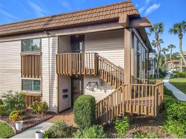 Exterior view of condo with private entrance and wooden staircase at 600 N Boundary Ave # 106D, Deland, FL 32720
