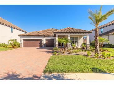 Two-story house with brown double door garage and a landscaped front yard at 219 Lugano Way, Debary, FL 32713