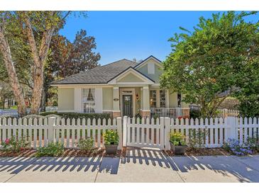 Charming one-story home with white picket fence and landscaped yard at 201 W Chancery Ln, Deland, FL 32724