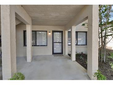 Inviting front porch with covered entryway, storm door, and neutral color palette at 1601 Big Tree Rd # 604, South Daytona, FL 32119