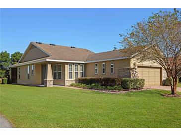One-story house with brown siding, a screened porch, and lush lawn at 4859 Nw 35Th Lane Rd, Ocala, FL 34482