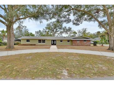 Ranch style home with mature landscaping and a long driveway at 900 Crescent Pkwy, Deland, FL 32724