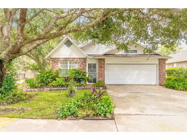 Brick ranch home with mature landscaping and attached garage at 22 Old Macon Dr, Ormond Beach, FL 32174