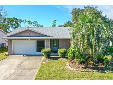 Single-story home with attached garage and landscaped yard at 2928 Bristol Ln, South Daytona, FL 32119