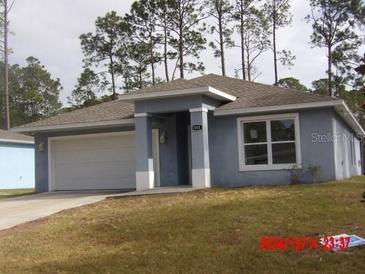 Charming single-story home with attached garage and inviting curb appeal at 2301 9Th Ave, Deland, FL 32724