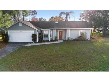 Charming single-story home with a welcoming front yard and attached garage at 2573 Delaware Rd, Deltona, FL 32738